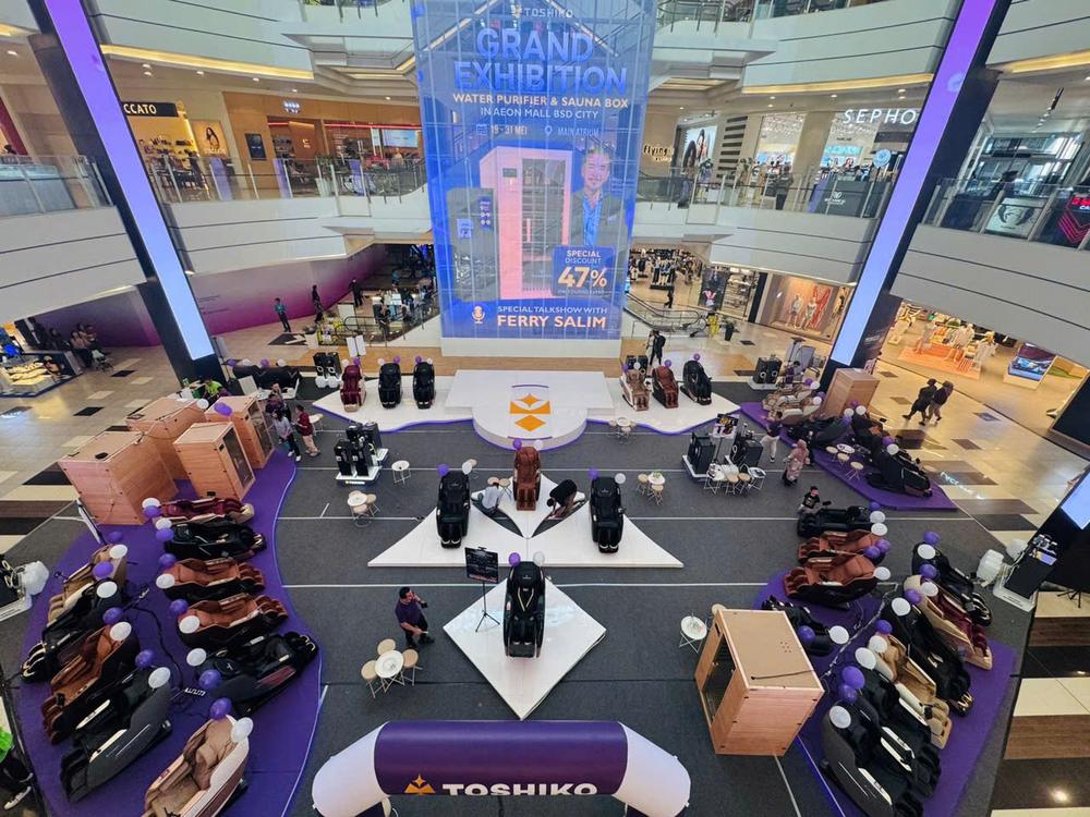 Grand Exhibition main atrium at AEON Mall BSD City, with massage chairs, sauna boxes and a talkshow stage